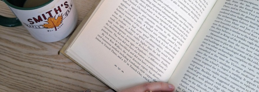 reading a book on a table